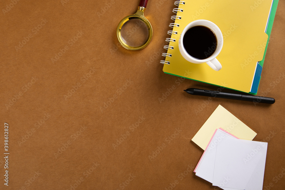 Poster coffee on notepad with magnifier on table