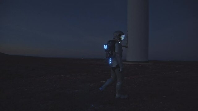 Interstellar. An astronaut-explorer walking through an endless field at night time. An astronaut has arrived on another planet. The animation is fantastic, the futuristic or space travel backgrounds.