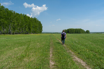 A man walks on a rural road