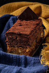 Sofia dessert with layers of chocolate mousse and caramelized peanuts covered with cocoa powder