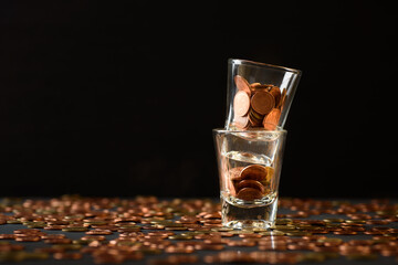 Concepts of finance, investing in assets with interest, dividend and profit. Coins are in the glass...