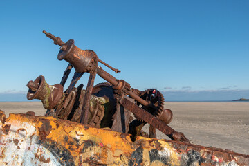 Selective focus shot of a shipwreck on a sandy beach in Norderney, Germany