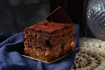 Sofia dessert with layers of chocolate mousse and caramelized peanuts covered with cocoa powder