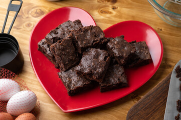 chocolate brownies on red heart shaped dish