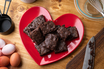 chocolate brownies on red heart shaped dish