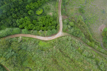 Aerial photography of a winding dirt switchback road in the wild bush