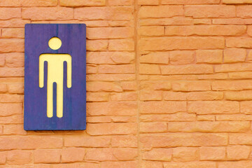 Men toilet sign on the brick