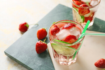 Glass of tasty strawberry mojito on table