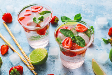 Glasses of fresh strawberry mojito on table