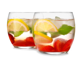 Glasses of fresh strawberry mojito on white background