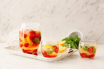 Glasses with strawberry mojito on table