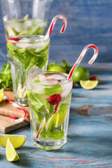 Glasses of fresh strawberry mojito on table