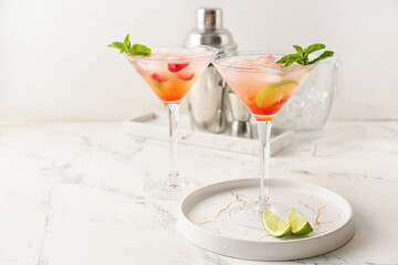 Glasses with strawberry mojito on table