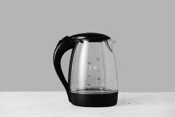 Transparent electric kettle on table