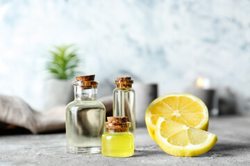 Bottles of lemon essential oil on table