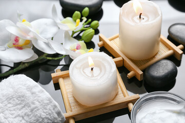 Beautiful spa composition with candles on dark background