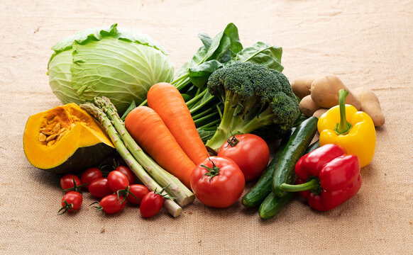 Many kinds of vegetables placed on a background of burlap