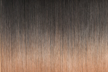 close up texture of single piece clip in straight black blended to orange two tone ombre style...