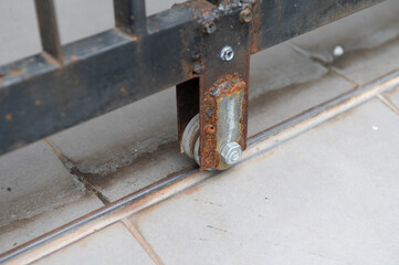 Close up of old sliding door wheel with rust