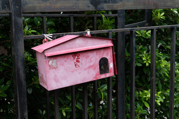 Close up of red old post box at a the front of home