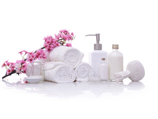 Obraz na płótnie Canvas Spa setting with Sakura cherry blossom , rolled towel ,oil ,salt in bottle, compressing herbal ball ,