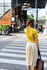 Woman yellow shirt gray protective mask on street