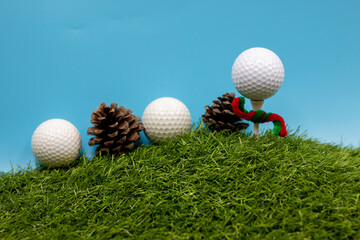 Golf ball with Christmas ribbon on blue sky background