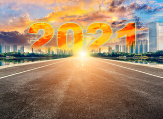 Fototapeta na wymiar Straight ahead to the modern city with the New Year 2021 concept. The 2021 number written in modern cities.