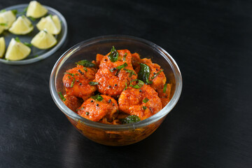 Top view spicy hot Bengali Prawn roast , shrimp masala Kerala fish curry. Indian food. Fish fry with red chili, curry leaf. Asian cuisine. Delicious  Goan fish curry clay pot. Grilled tiger shrimps