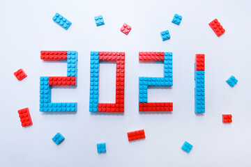 New year, 2021. Lettering from a children's constructor on a white background. Toys in isolation. copy space. The concept of a hobby and learning