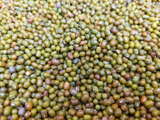 Green and golden colored mung beans close up view