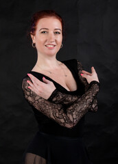 Beautiful dancer studio portrait posing on black background.
