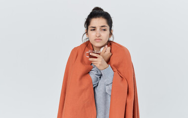 Woman in warm clothes with a napkin in her hand runny nose health problems a cup of tea