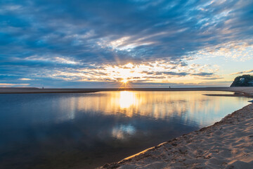 Sunrise with sunburst and clouds over the Lagoon