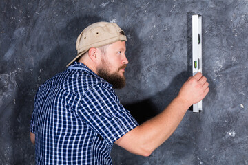 Solid bearded foreman with a plumb