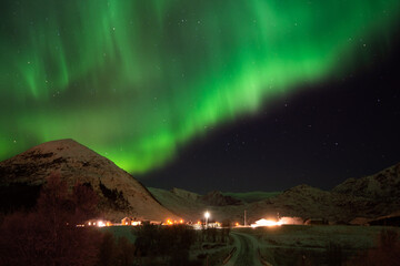 North green lighting of aurora over the mountains in Lofoten island Norway