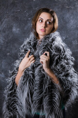 Pretty young woman dressed in fur coat