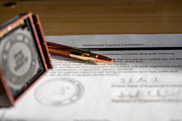 Selective focus on generic professional engineer, architecture. or surveyor stamp and certification statement