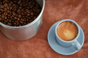 Close up espresso shot with coffee bean on textile background