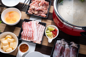 Sukiyaki . Preparation of raw materials,beef,egg ,tofu,vegetable and mung bean noodle  for sukiyaki using hot pots.