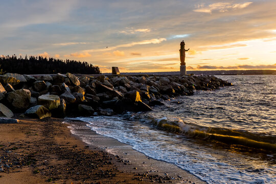 Welcome Figure at Ambleside Park near sunset - West Vancouver, BC Canada