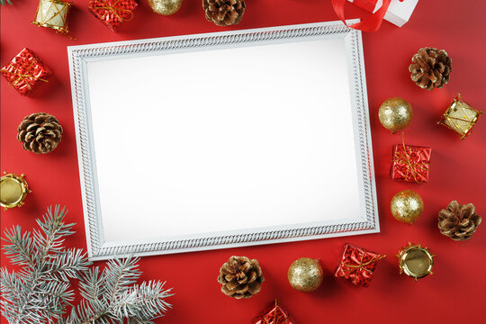The layout of the frame with the free white space on a red background and Christmas decorations.