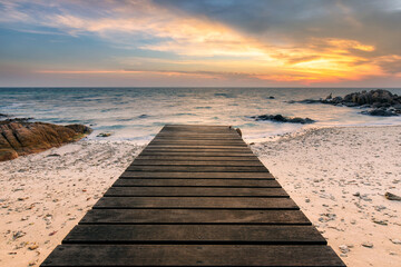 Obraz na płótnie Canvas Sea shore scenic tourist pathway bridge under sunrise. Beautiful beach in sunrise