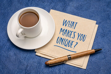 What makes you unique? Handwriting on a napkin with a cup of coffee. Personal branding and...