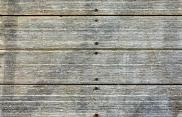 Old gray vintage grunge background from horizontal wooden planks.