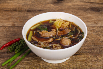 Thai style soup with meat and mushrooms