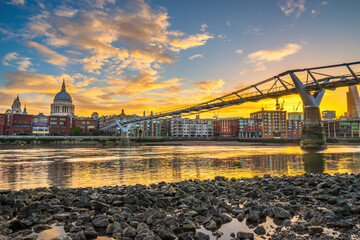 Millennium Bridge and St. Paul's cathedral at sunrise in London