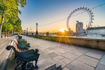 London eye at sunrise. The London Eye, or the Millennium Wheel, a cantilevered observation wheel on...