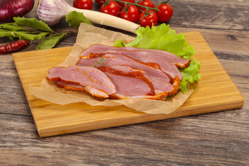 Sliced smoked duck breast served salad