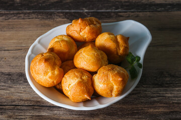 Sweet tasty profiteroles heap in the bowl